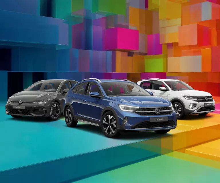 Drei VW-Modelle vor einem bunten, geometrischen Hintergrund aus leuchtenden 3D-Blöcken.