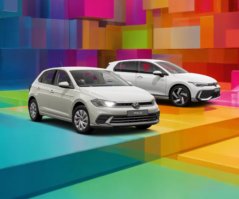 Drei VW-Modelle vor einem bunten, geometrischen Hintergrund aus leuchtenden 3D-Blöcken.