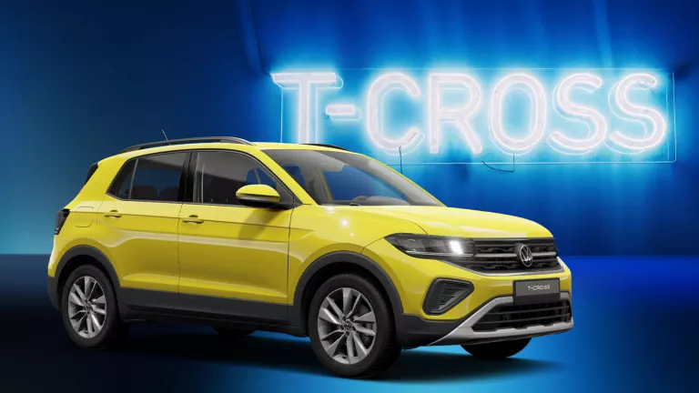 Gelber VW T-Cross SUV mit fünf Türen und einem markanten Kühlergrill, vor einem blauen Hintergrund mit der leuchtenden Aufschrift „T-CROSS“.