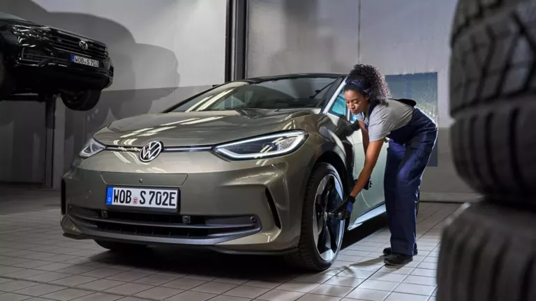 VW Servicemitarbeiterin prüft Reifen eines VW ID.3 – Volkswagen Fleet Service für Großkunden und Wagenparkbesitzer