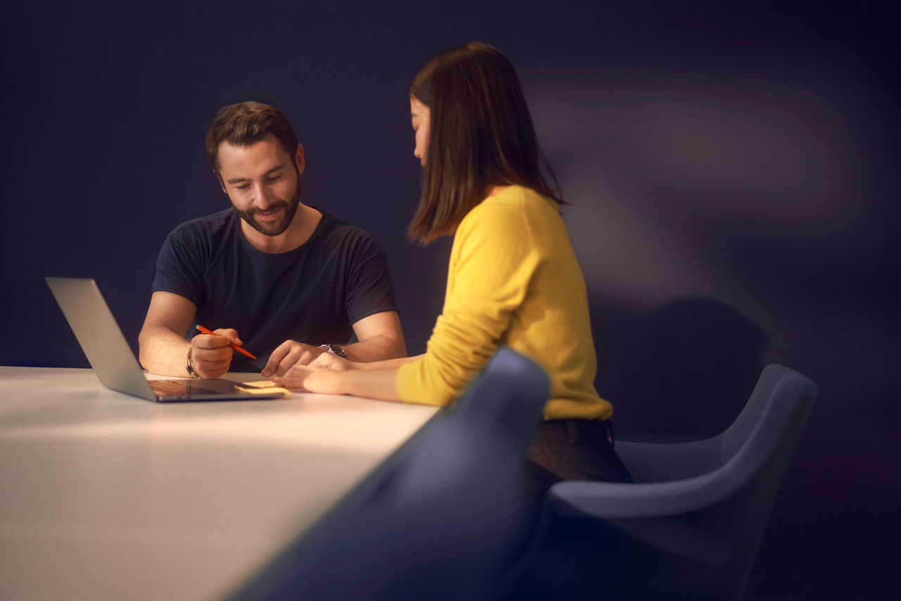 woman and man in a conference room