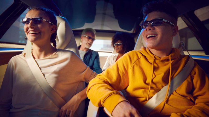 4 people sat in concept car with glasses on
