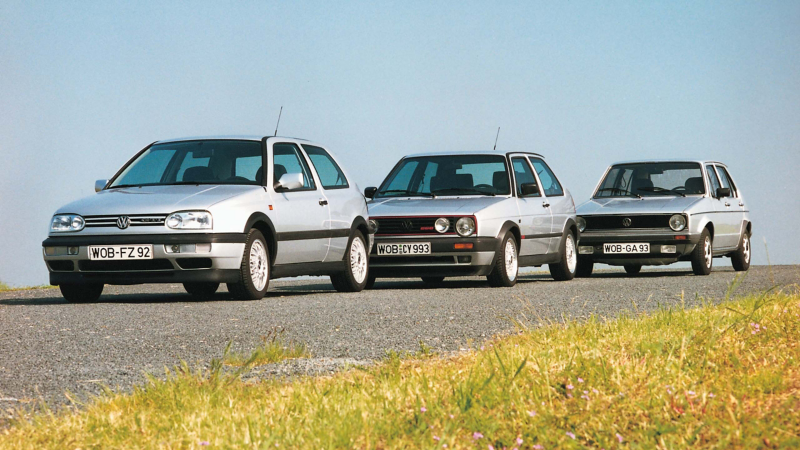 Three generations of Golf GTI's lined up on a track