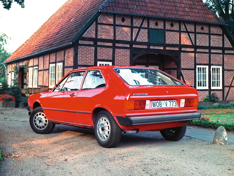 Red VW Scirocco parked outside house
