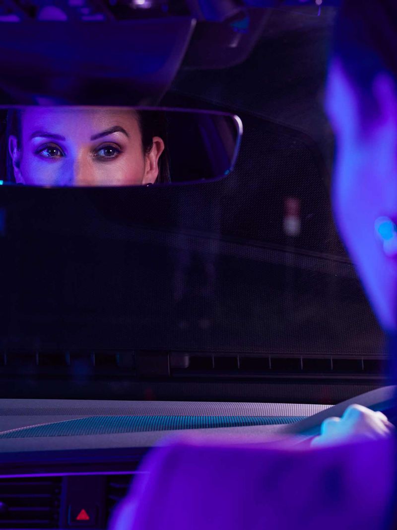 Close up of womans eyes in rearview mirror of Volkswagen Tiguan.