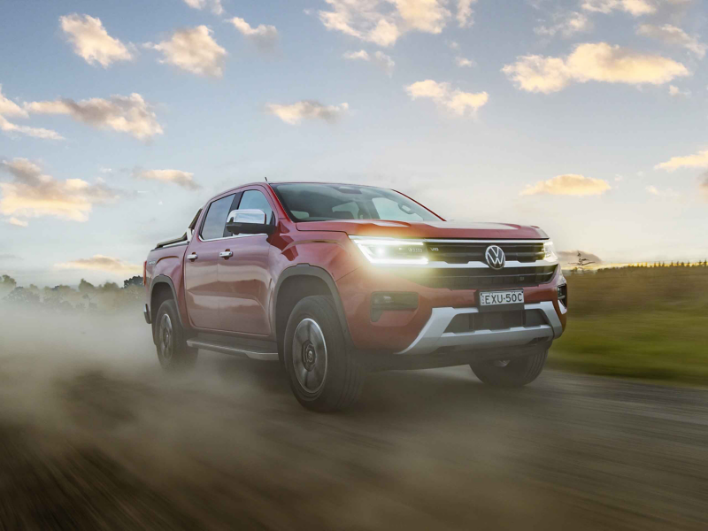 Red Amarok driving in the country at sunset