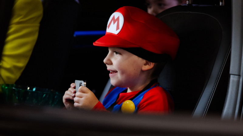 Child dressed as a video game character sitting inside a Volkswagen ID. Buzz at MCM Comic Con London 2026