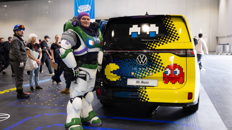 Buzz Lightyear cosplayer standing beside a PAC-MAN themed Volkswagen ID. Buzz at MCM Comic Con London