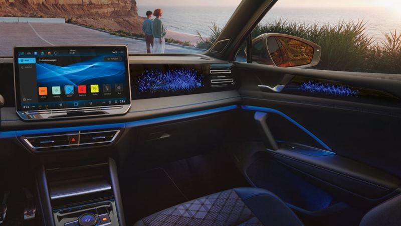 Vue intérieure du VW Tiguan, l'écran affiche les réglages d'éclairage d'ambiance en option, l'habitacle est illuminé en bleu.