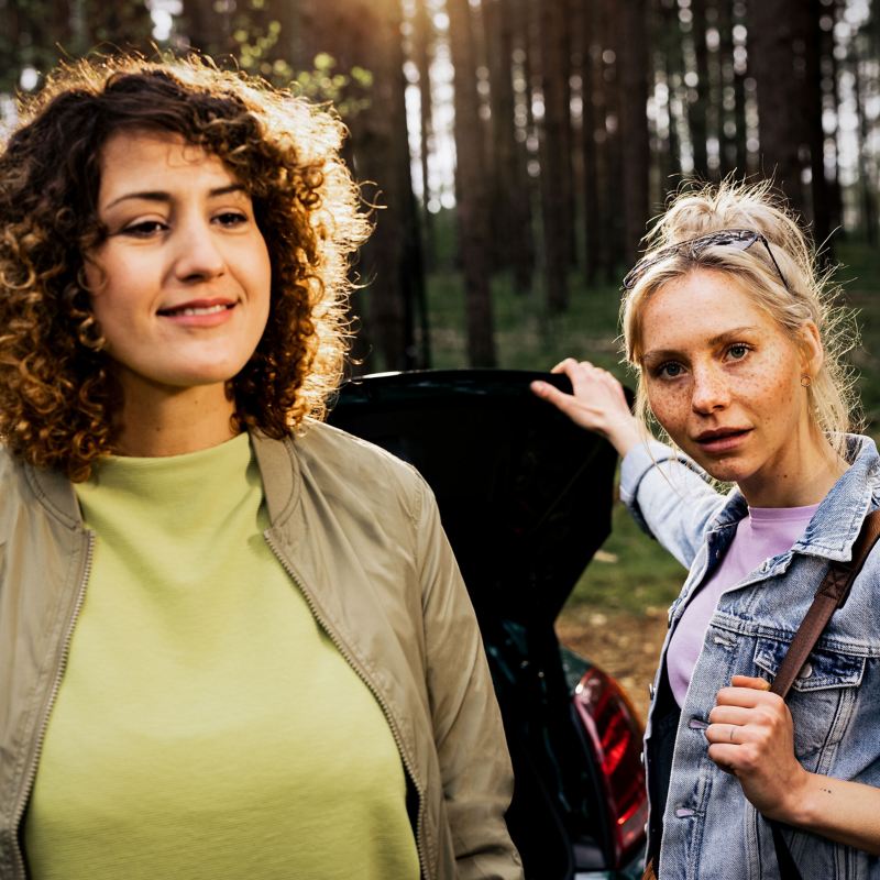 Две женщины у багажного отделения своего VW — поездка на природу на Volkswagen