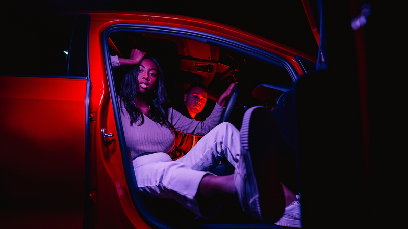 Couples inside the GOLF GTI watching towards the camera with driver seat open