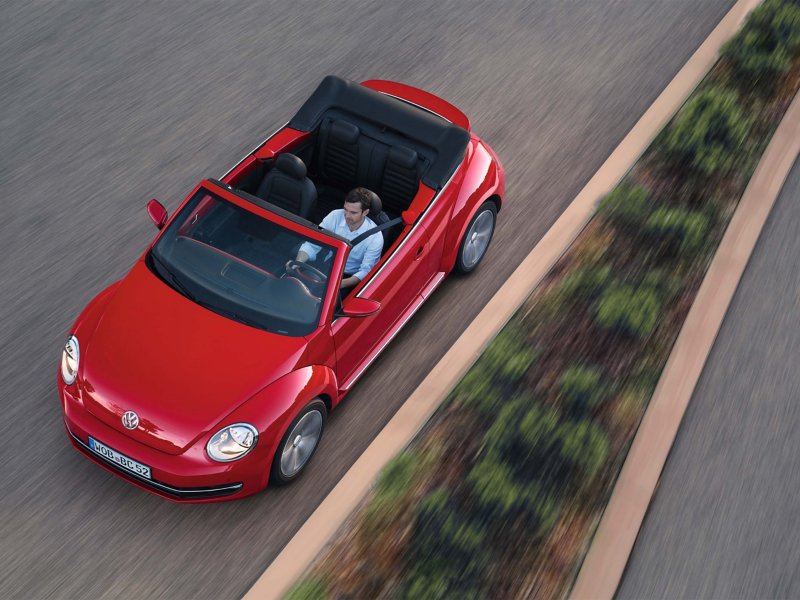 Red convertible VW Beetle ariel shot 