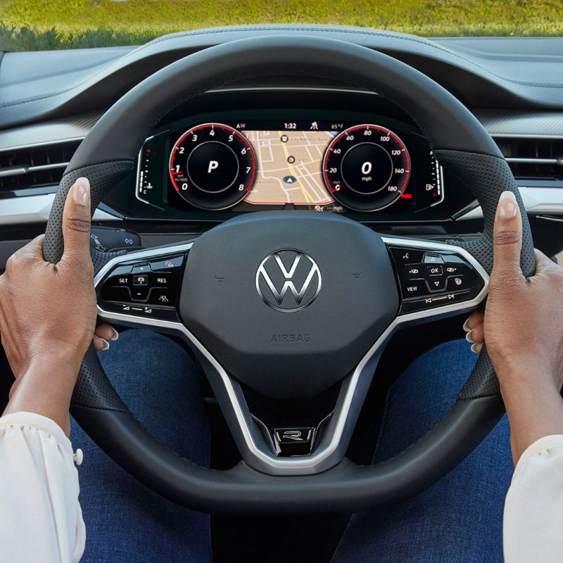 A woman keeping her hands on the Volkswagen Arteon’s steering wheel.