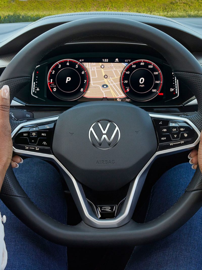 A woman keeping her hands on the Volkswagen Arteon’s steering wheel., link out to VW test drive page