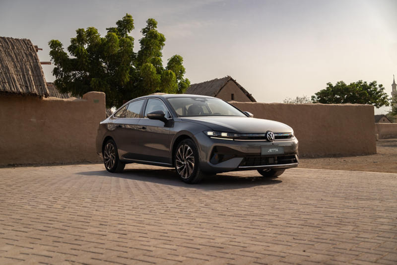 Front 3/4 angle of a silver Jetta on a beige bricked driveway
