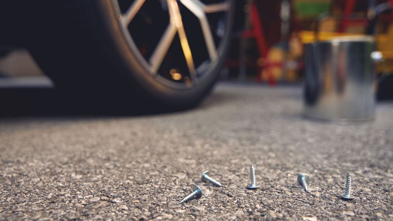 Close-up of VW wheel, various nails in the foreground – AirStop® tyres