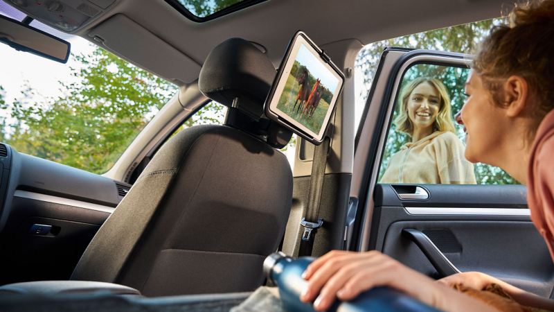 Teenager watches horse film on tablet attached to a tablet holder – accessories for previous models