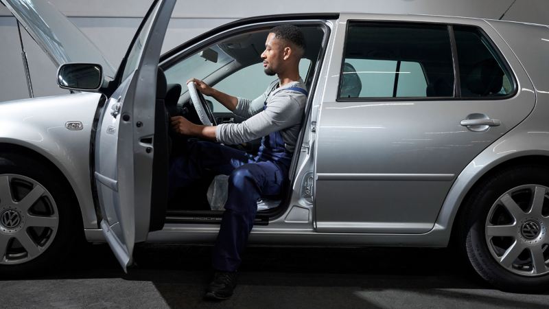 Un empleado del servicio técnico de VW revisa el interior de un Golf 4 