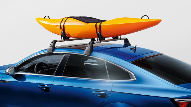 A kayak holder from VW Accessories on top of a blue VW Arteon model