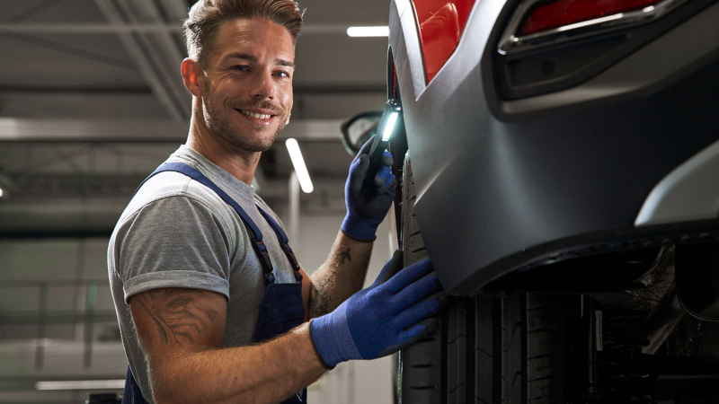 Volkswagen mechanic inspecting car tyre 