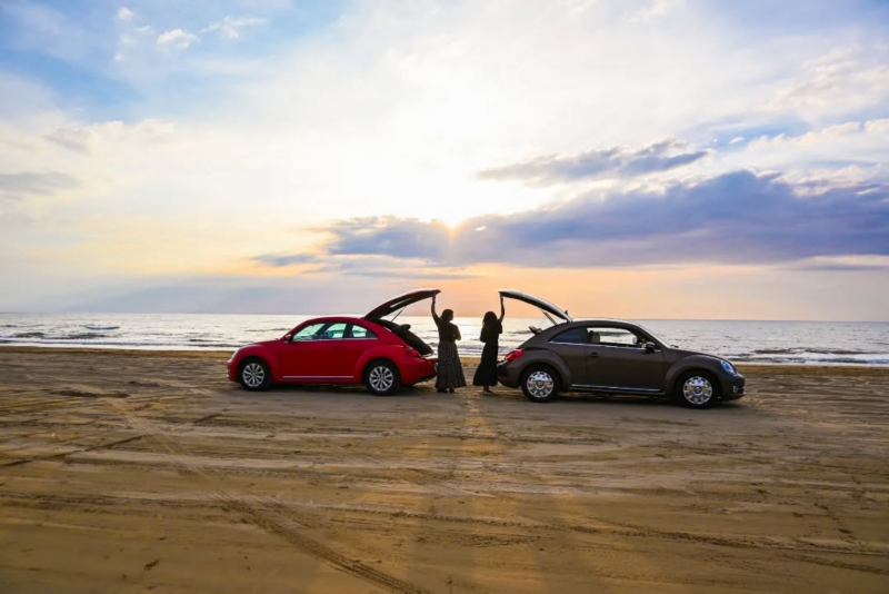 2 volkswagen cars on the beach