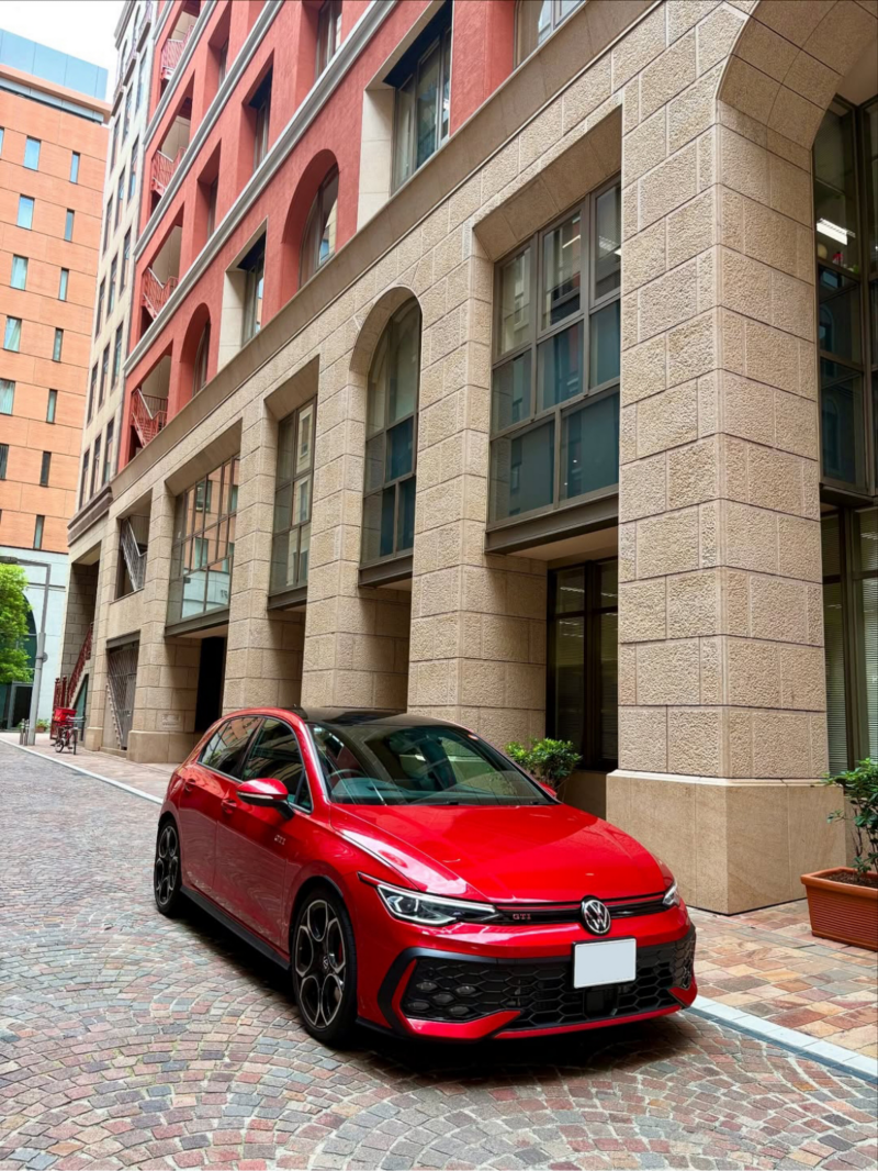 red car in front of the building
