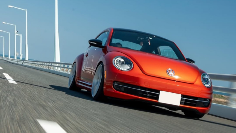 volkswagen red car on the highway