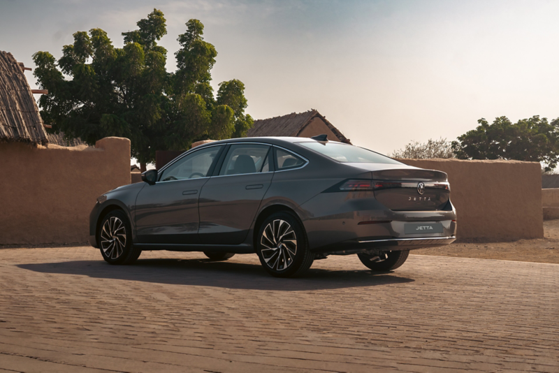 rear 3/4 view of the Jetta on a  beige driveway