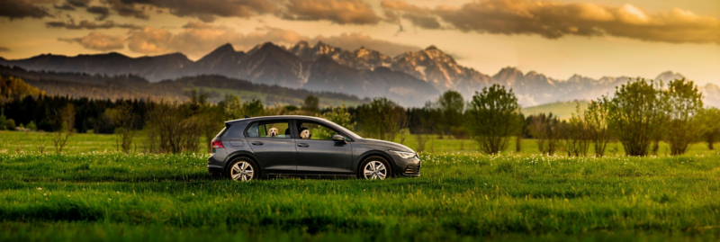 Czarny Volkswagen na tle górskiego krajobrazu.