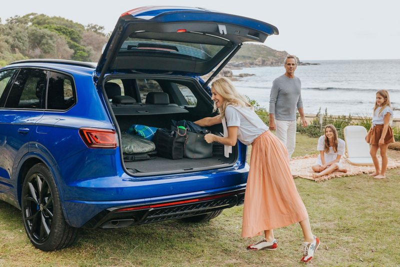Touareg R eHybrid car boot open with family next to car