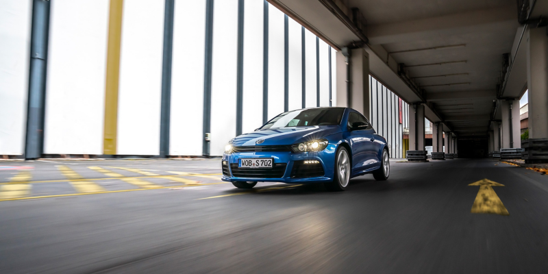 Der VW R Scirocco R in Blau fährt in einem Parkhaus mit gelben Fahrbahnmarkierungen