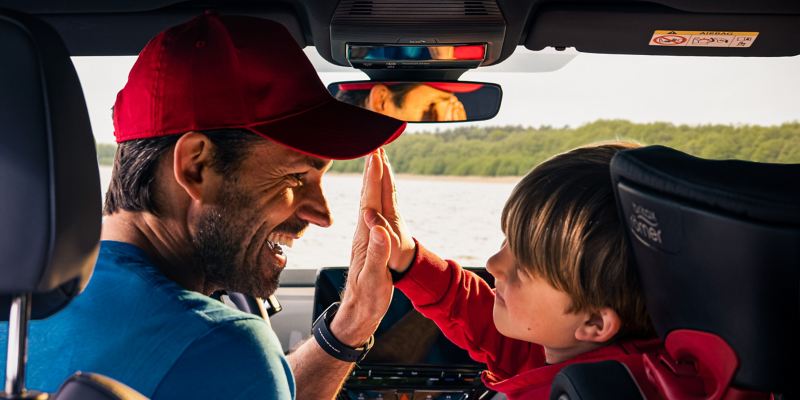 Vater und Sohn sind glücklich über den aufregenden Ausflug – dank dem VW ID.4 und seinen Transportlösungen