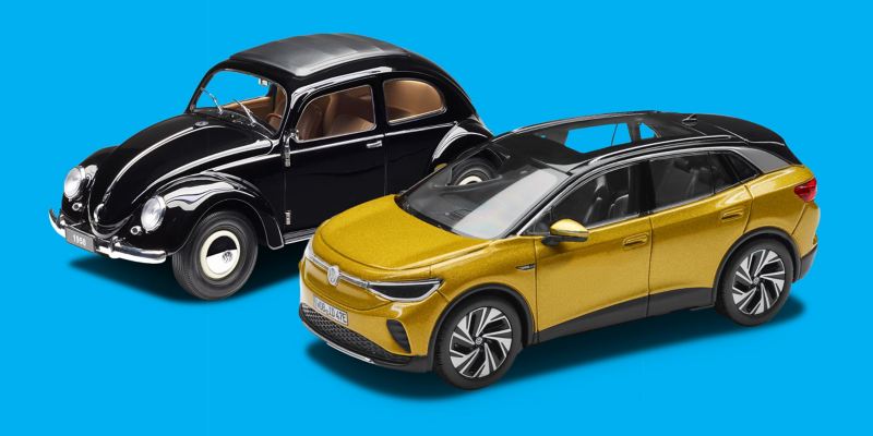 Modelos en miniatura de Accesorios Volkswagen: un Beetle negro de 1950 y el VW ID.4 en Amarillo miel
