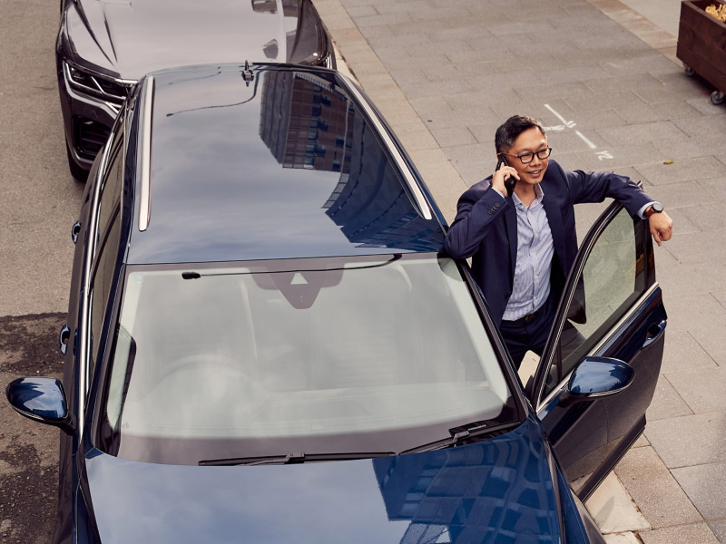Man on phone next to Volkswagen SUV