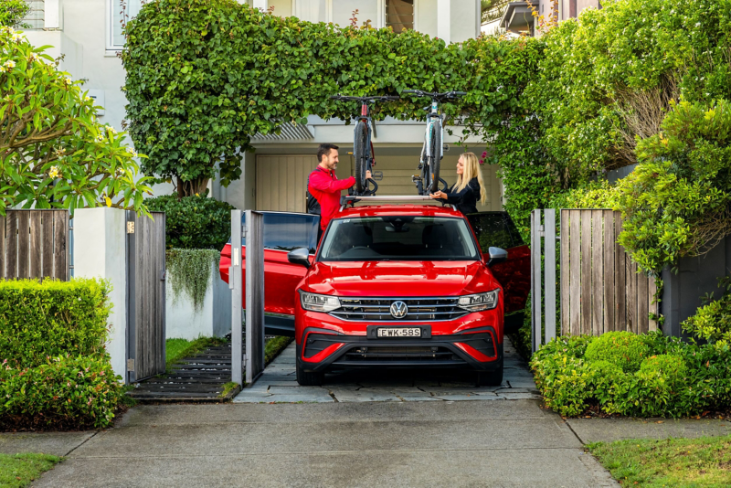 VW Tiguan Allspace featuring the roof racks being loaded up with 2 bicycles.