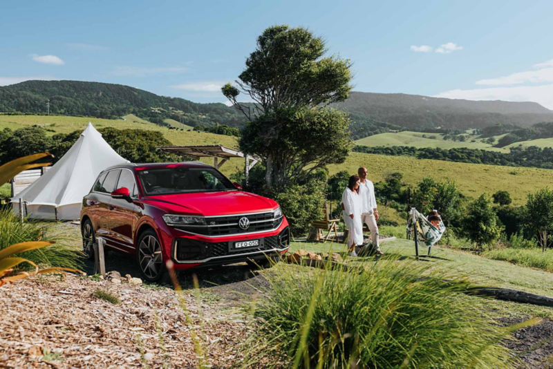 Volkswagen SUV parked outside with a family