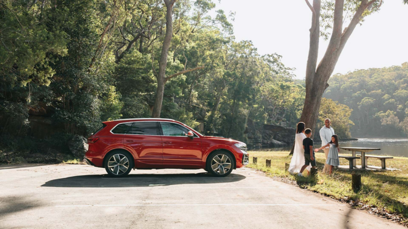 New 2024 Touareg parked by lake, side view