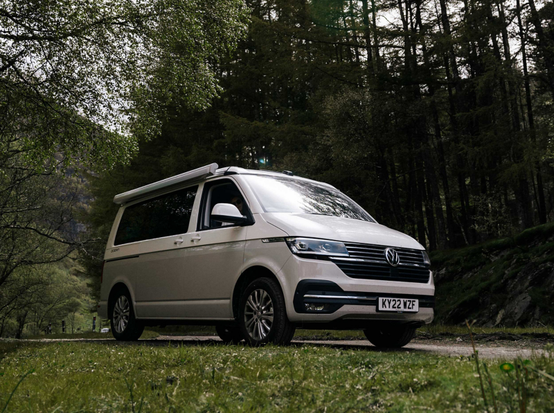 Photo showing a VW California parked against a countryside background. 