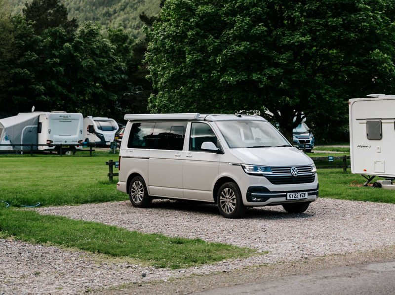 Photo showing a VW California parked at a caravan park. 