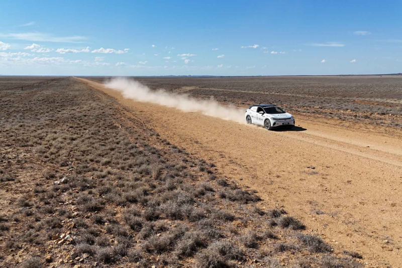 ID.4 driving through desert land with dust trail