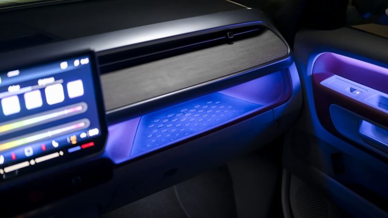 A close-up view of the dashboard in the Volkswagen ID. Buzz 2025, showcasing the customizable 30-color ambient lighting 