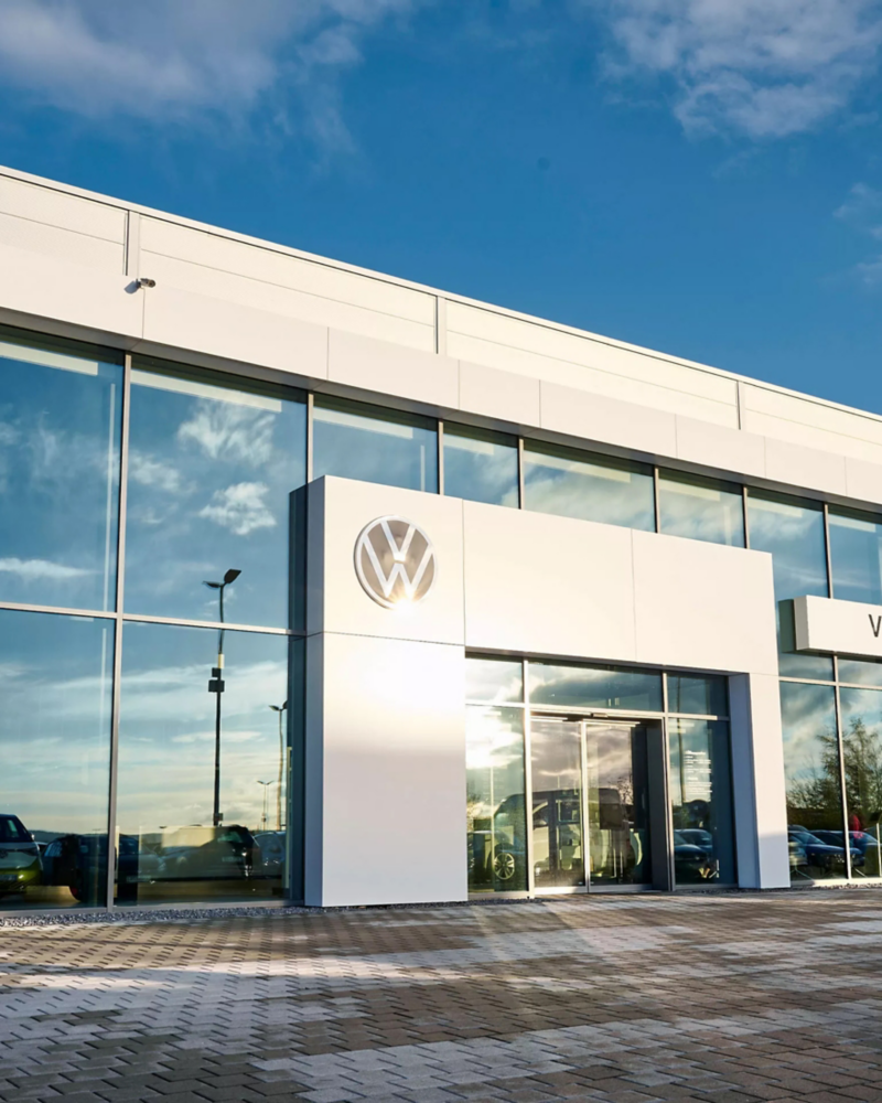 Exterior of Volkswagen dealership at sunset.