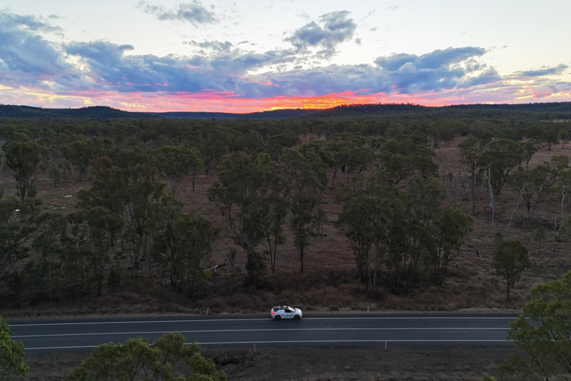 Volkswagen driving with sunrise, drone shot