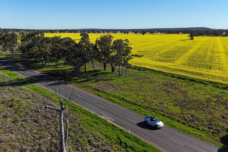 ID.4 driving past green fields