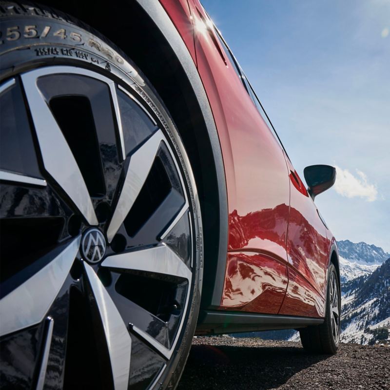 VW ID.5 GTX in a snowy mountain landscape with the left front wheel in focus