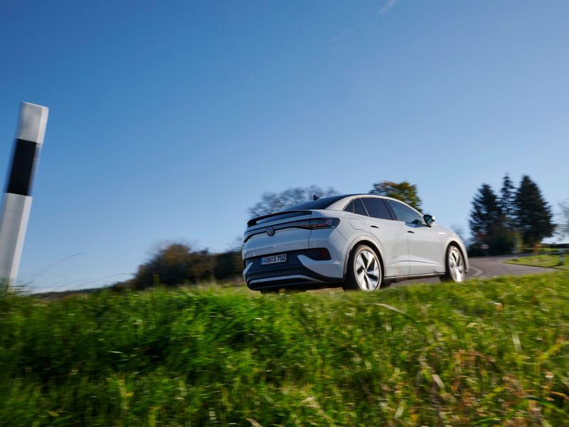 A VW ID. model drives through nature