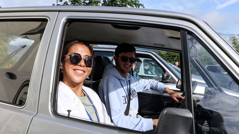 Un couple assis dans une vieille VW Golf