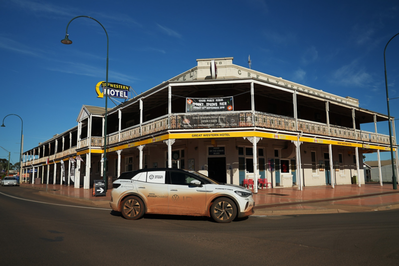 Image of red dusty ID.4 parked outside a hotel