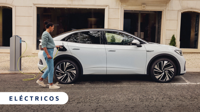 Un Volkswagen eléctrico de color blanco conectado a carga