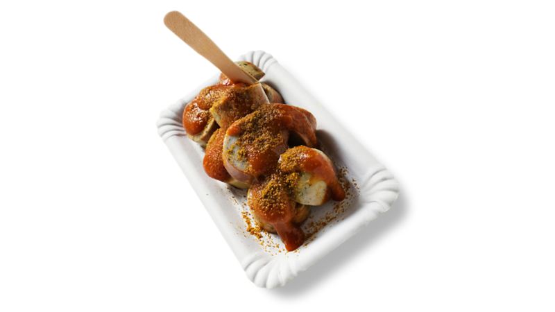 Topshot of a portion of Currywurst